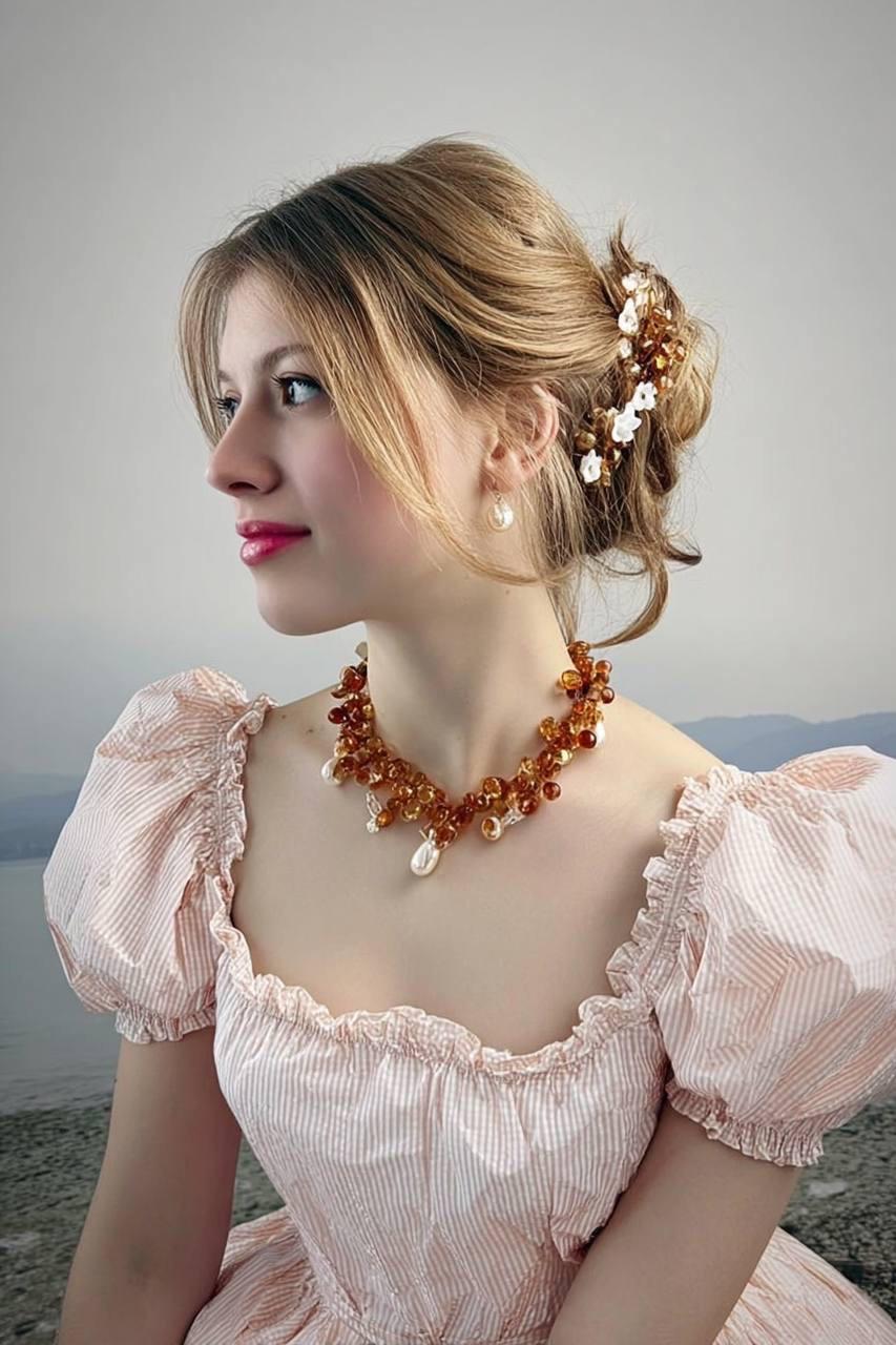 Amber and pearl necklace presented on a model